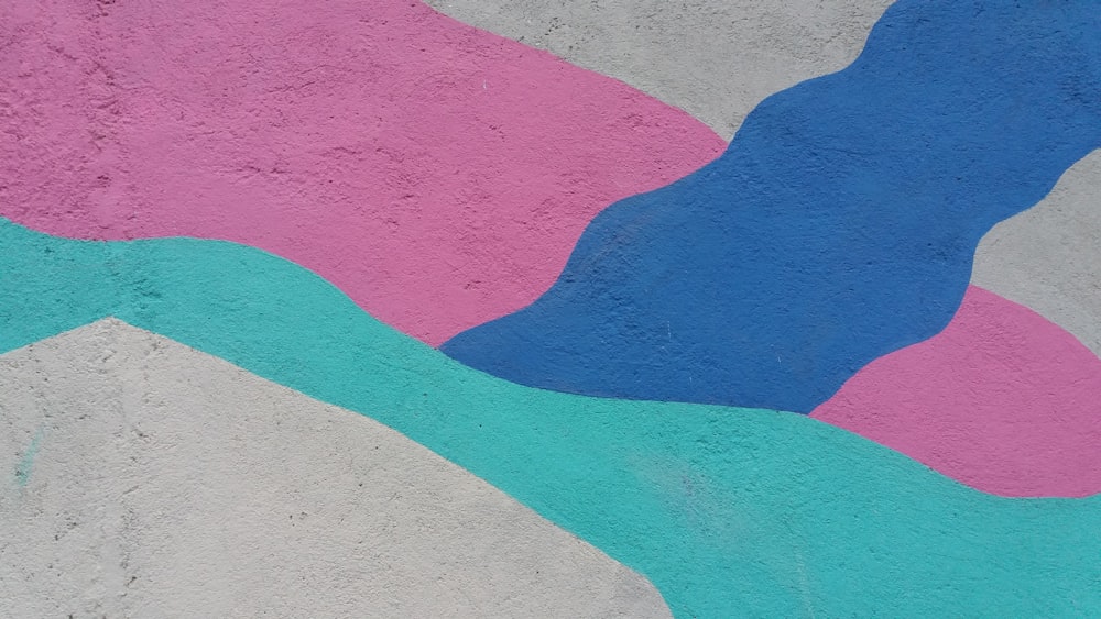 a skateboarder doing a trick on a colorful wall