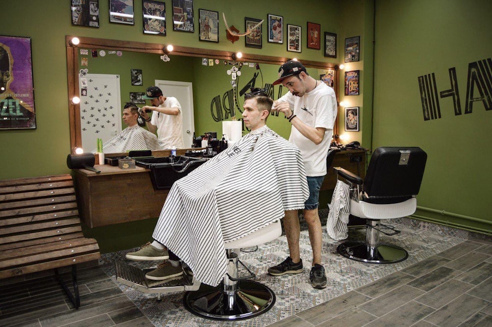 a man getting his hair cut in a barber shop