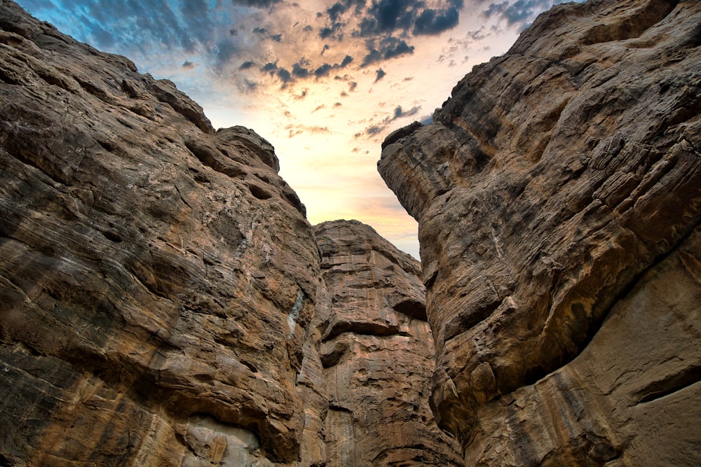 a person climbing up the side of a mountain