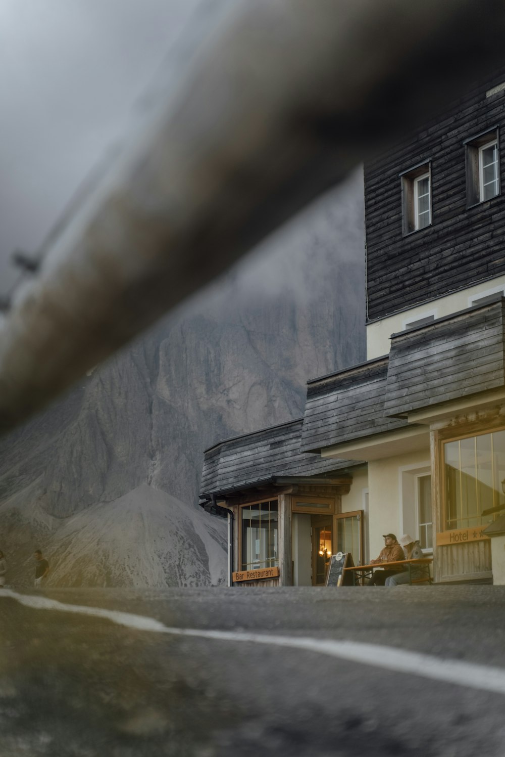 a blurry photo of a store front with mountains in the background