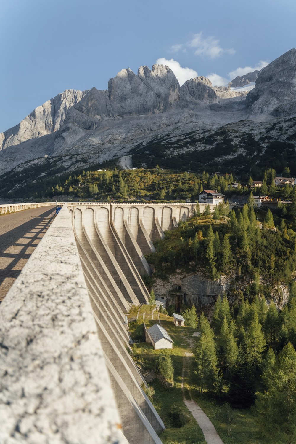 a large bridge over a river with mountains in the background