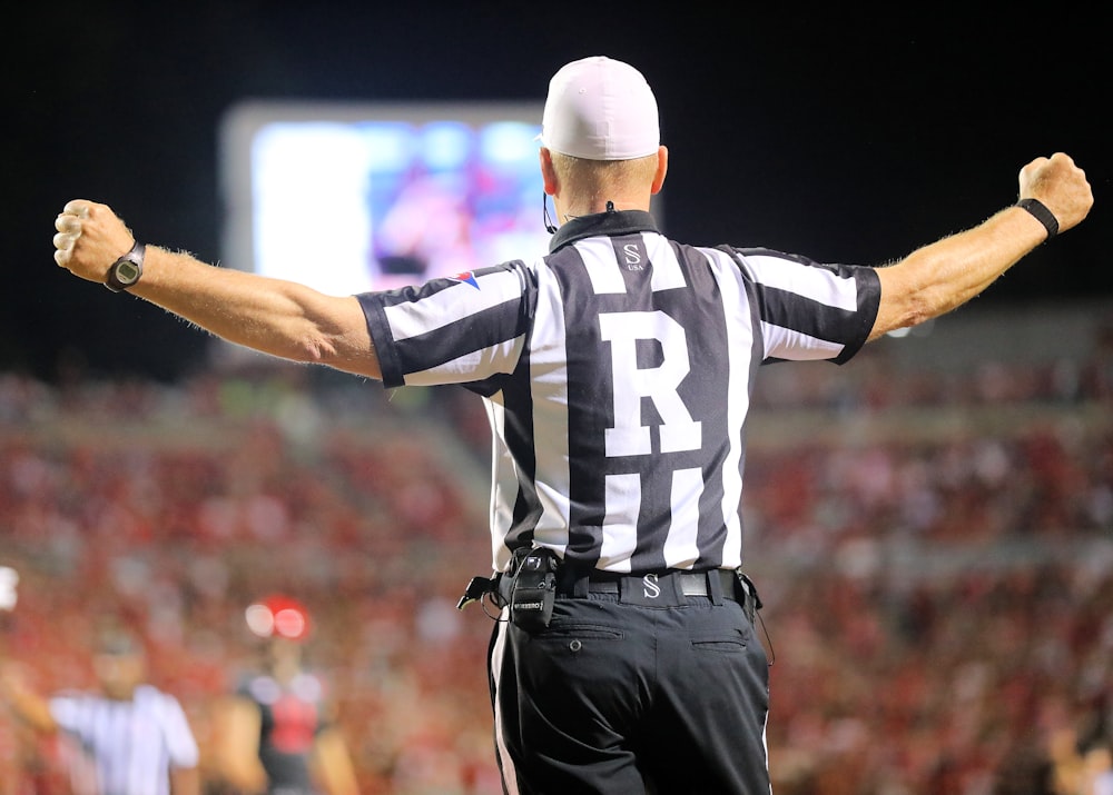 a referee in a black and white striped uniform