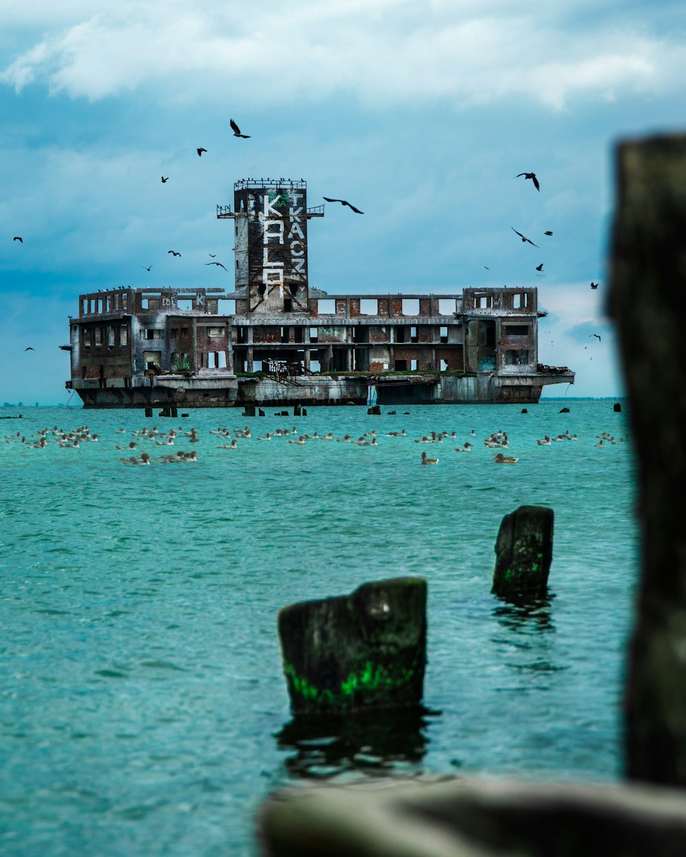 a large building sitting in the middle of a body of water