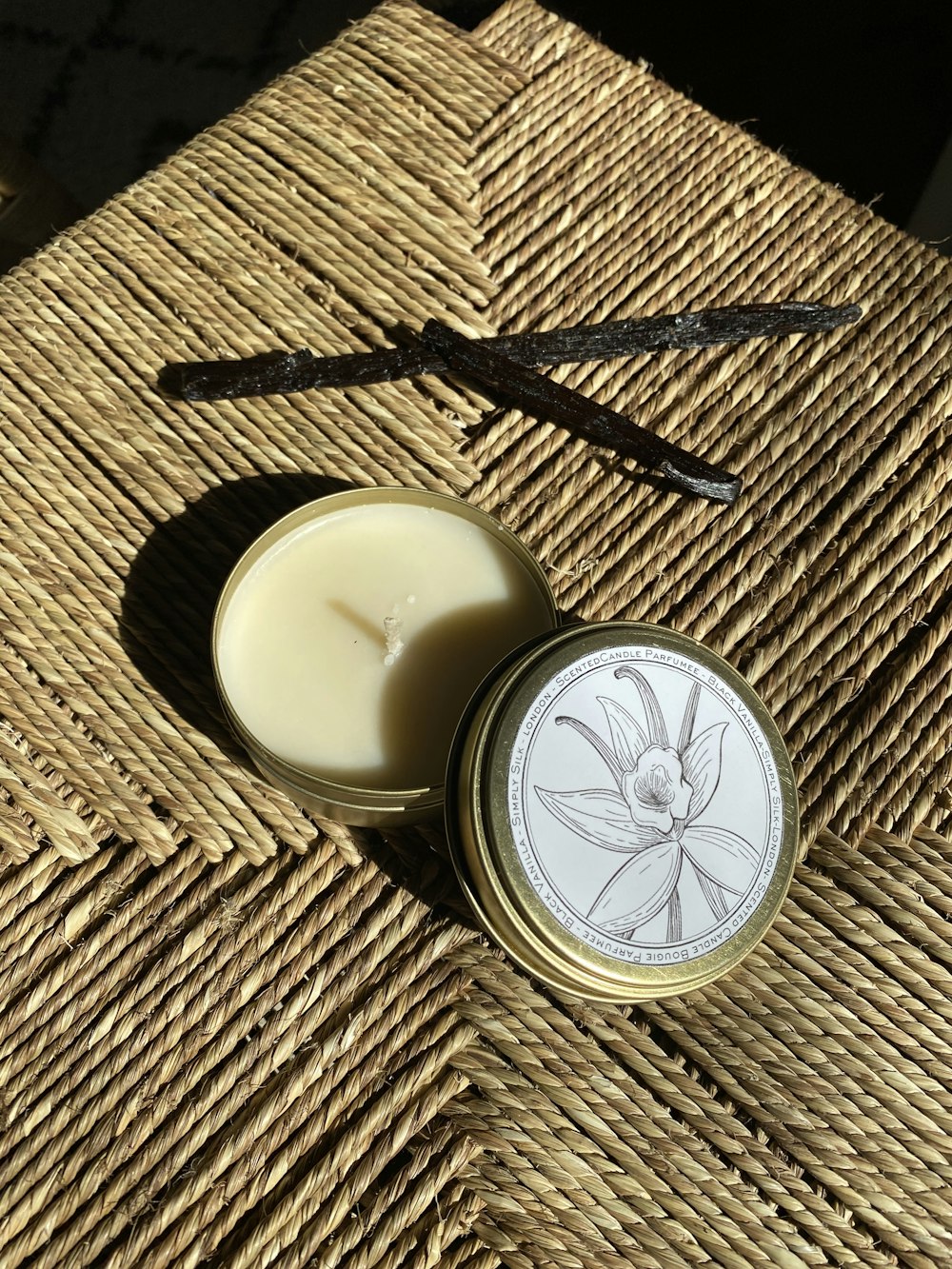 a candle sitting on top of a wicker table