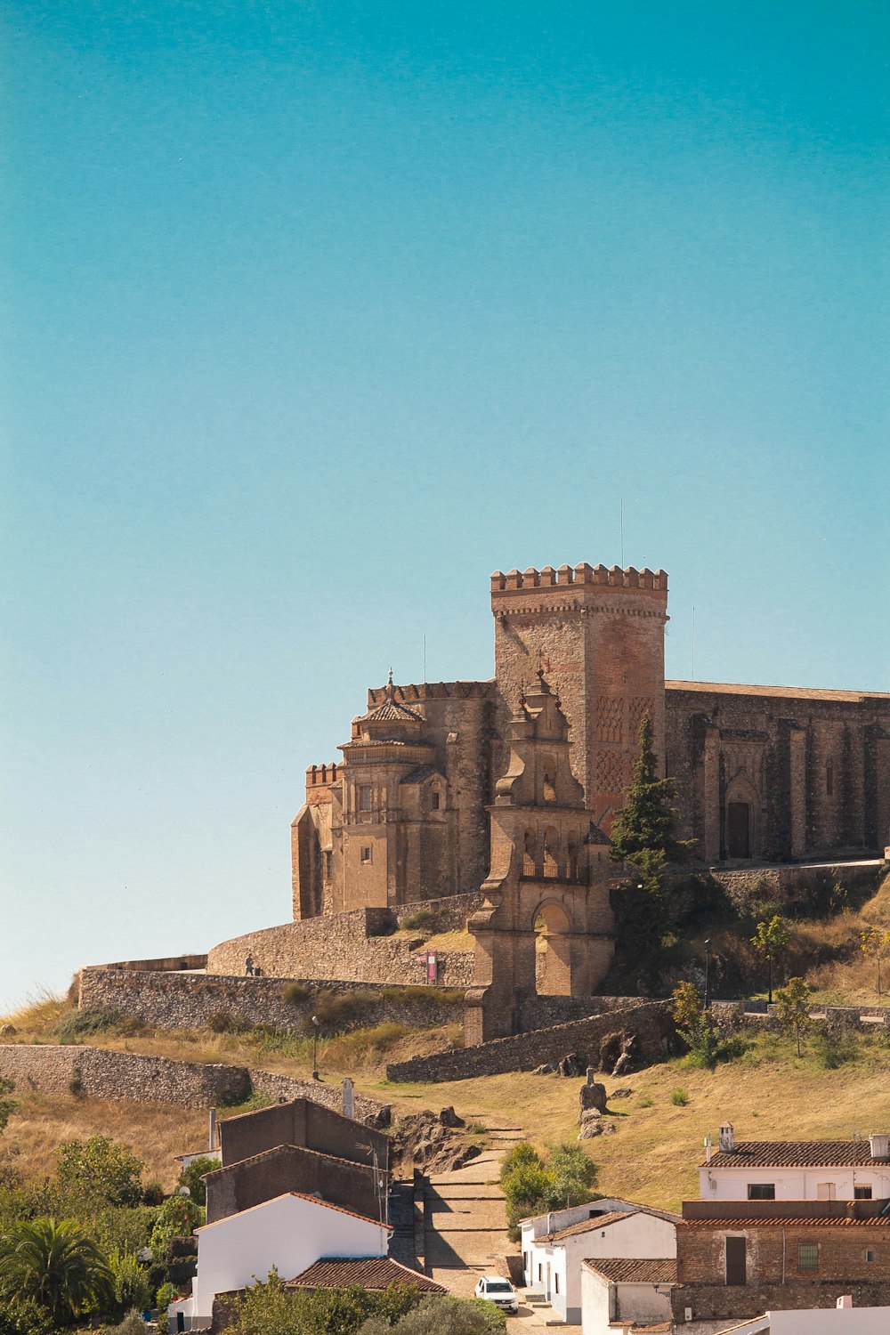 a castle on top of a hill with a sky background