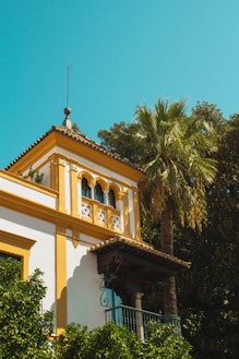 a yellow and white building with a clock tower