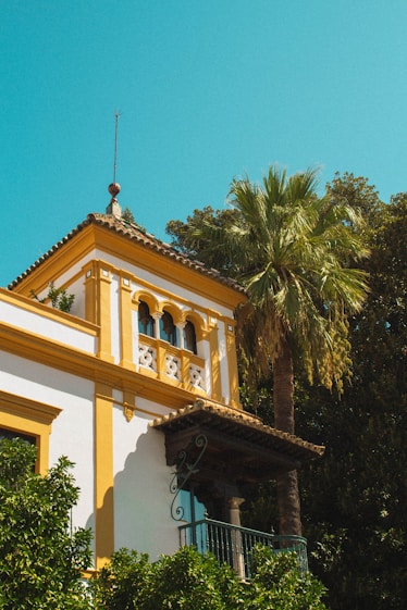 a yellow and white building with a clock tower