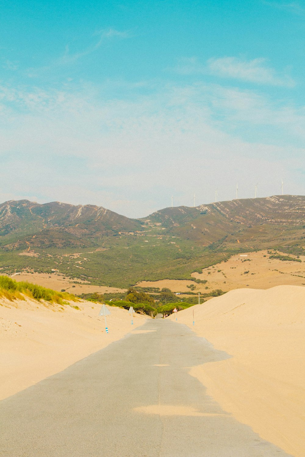 an empty road in the middle of a desert