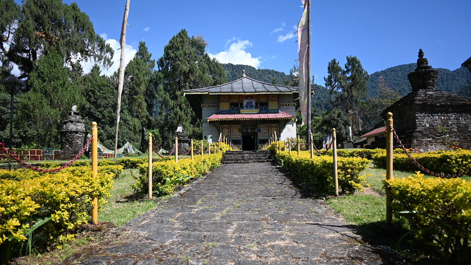 A stone path between flowerbeds and chortens leads to Dubdi Monastery above Yuksom, West Sikkim