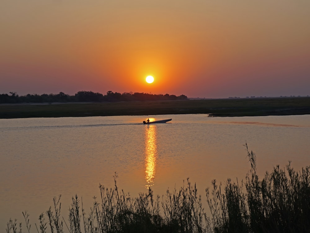 the sun is setting over a body of water