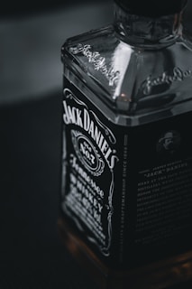 Close-up of a rich amber single barrel whiskey bottle with a handwritten label.