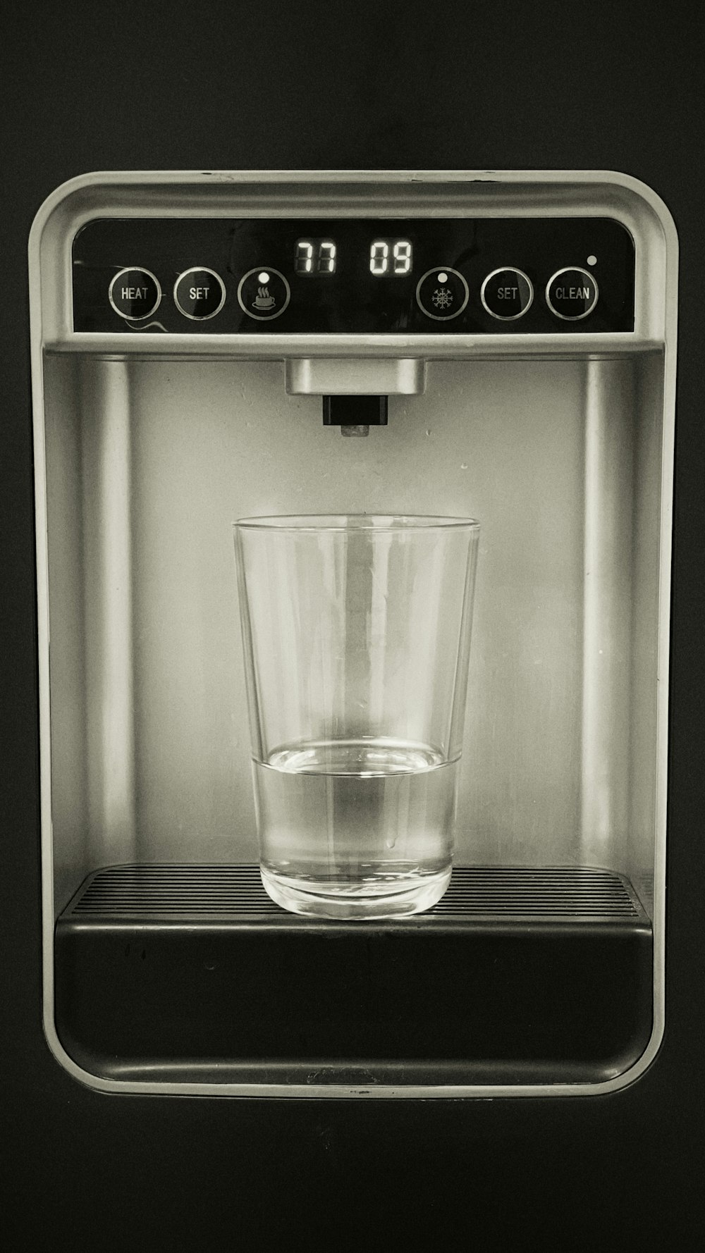 a glass of water sitting on top of a stove