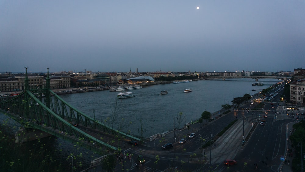 a view of a river and a bridge at dusk