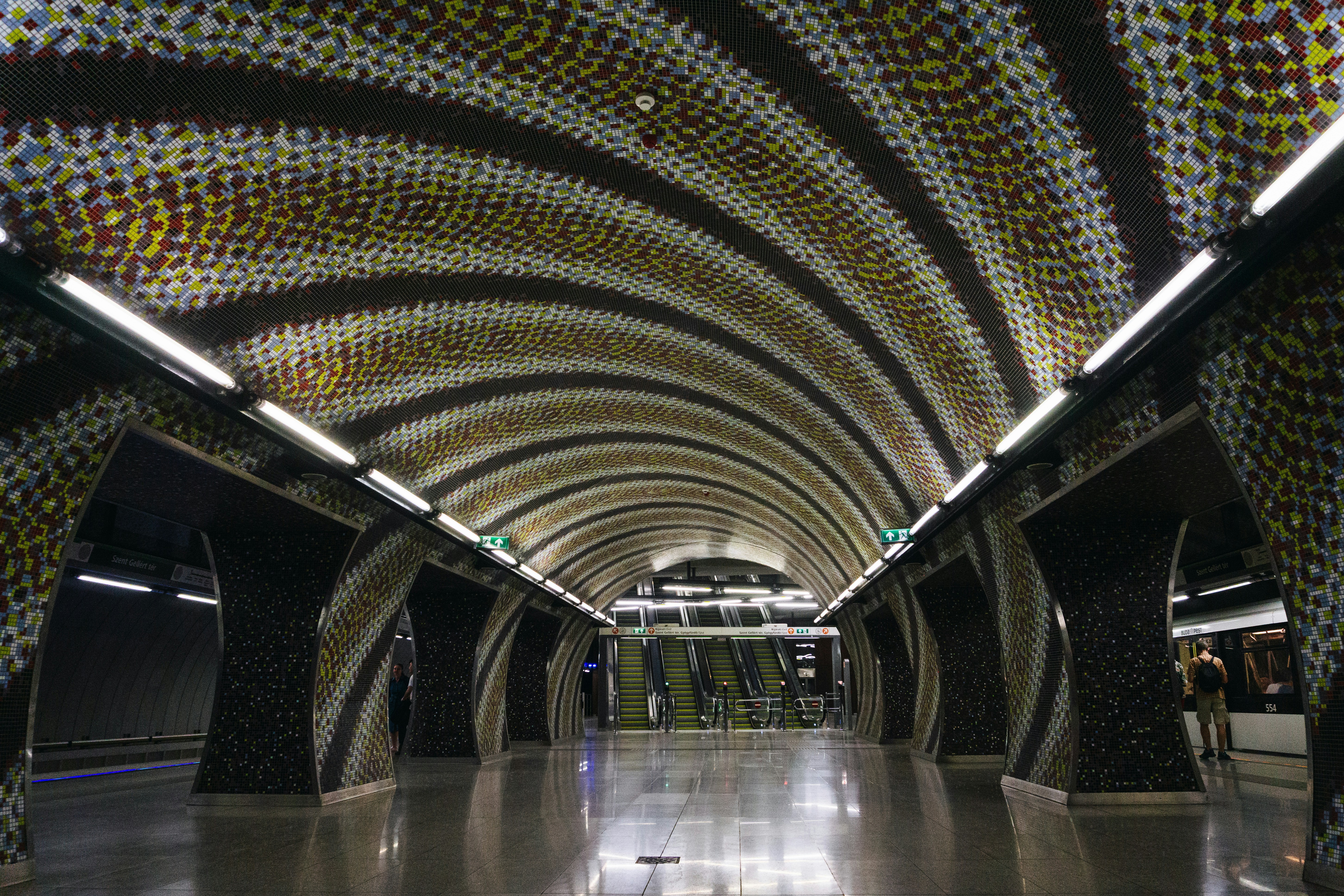 a very long tunnel with a lot of dots on the ceiling