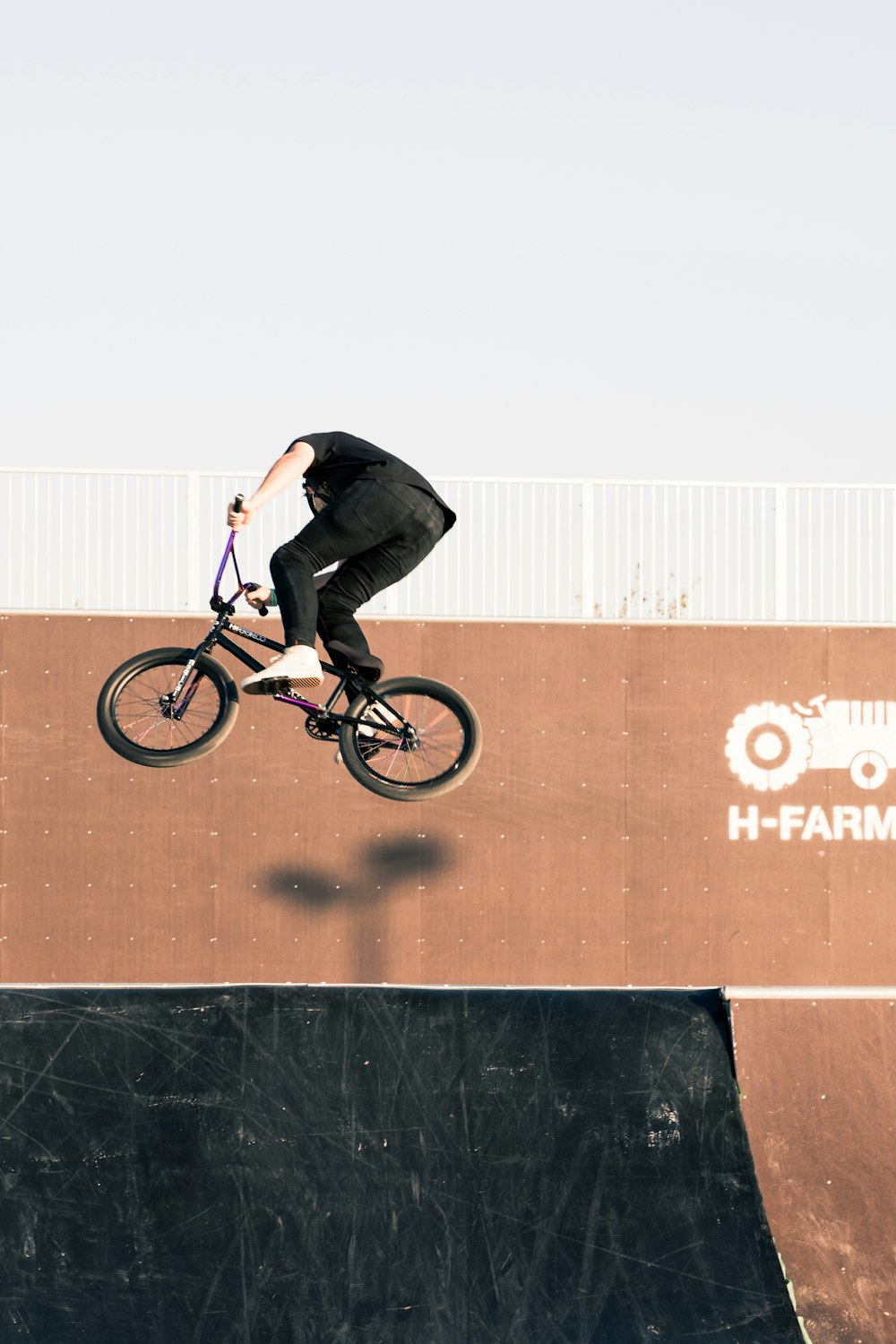 a man riding a bike up the side of a ramp