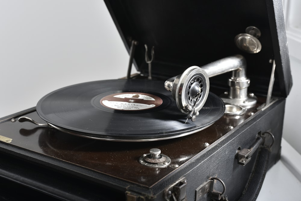 a record player sitting on top of a suitcase