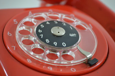 Close-up of a classic desk telephone with clear buttons and display