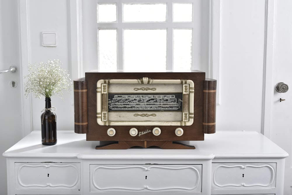 an old fashioned radio sitting on top of a white table