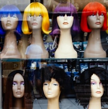 a bunch of wigs that are on display