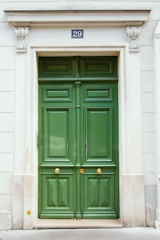 a green door with a sign on the side of it