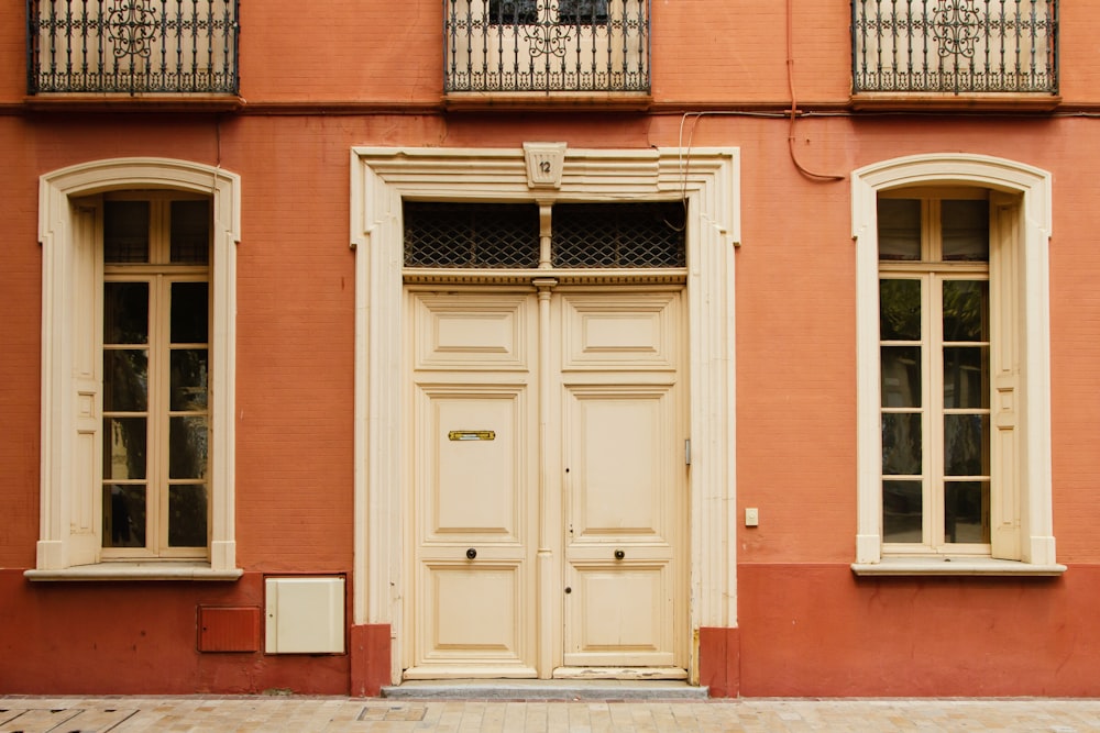 an orange building with two doors and windows