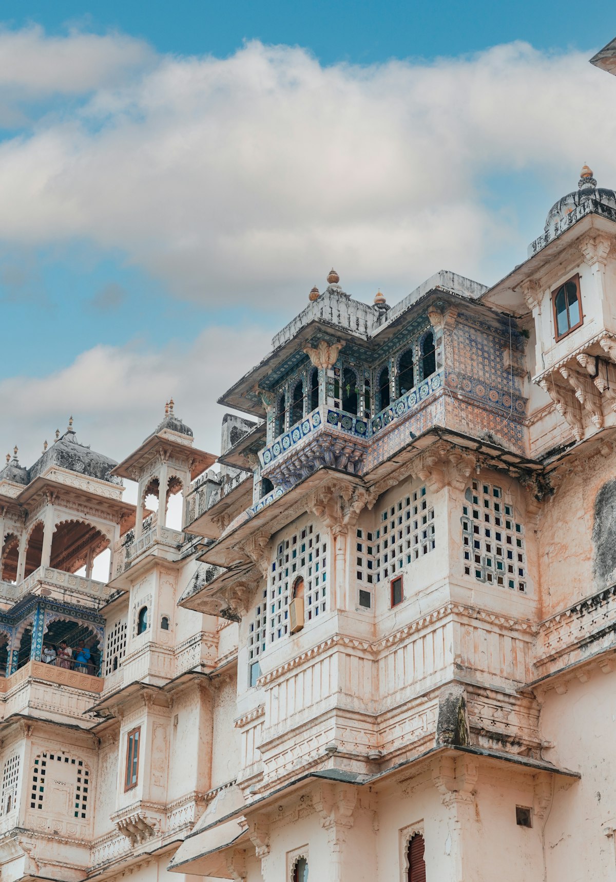 City Palace stone facade with ornate windows and balconies in the Udaipur old city
