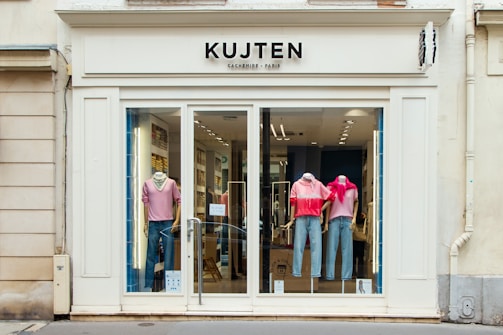 a store front with mannequins dressed in pink and blue
