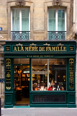 a store front with a green awning on a city street