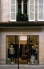 a store front with mannequins in the window