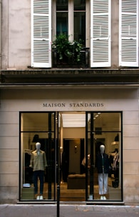 a store front with mannequins in the window