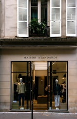 a store front with mannequins in the window