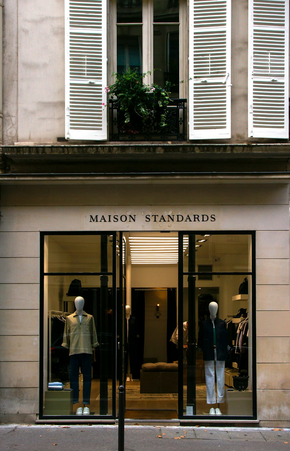 a store front with mannequins in the window