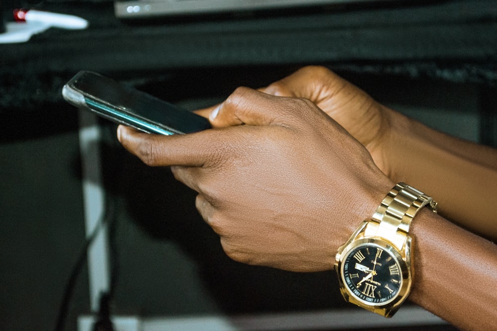 a close up of a person holding a cell phone