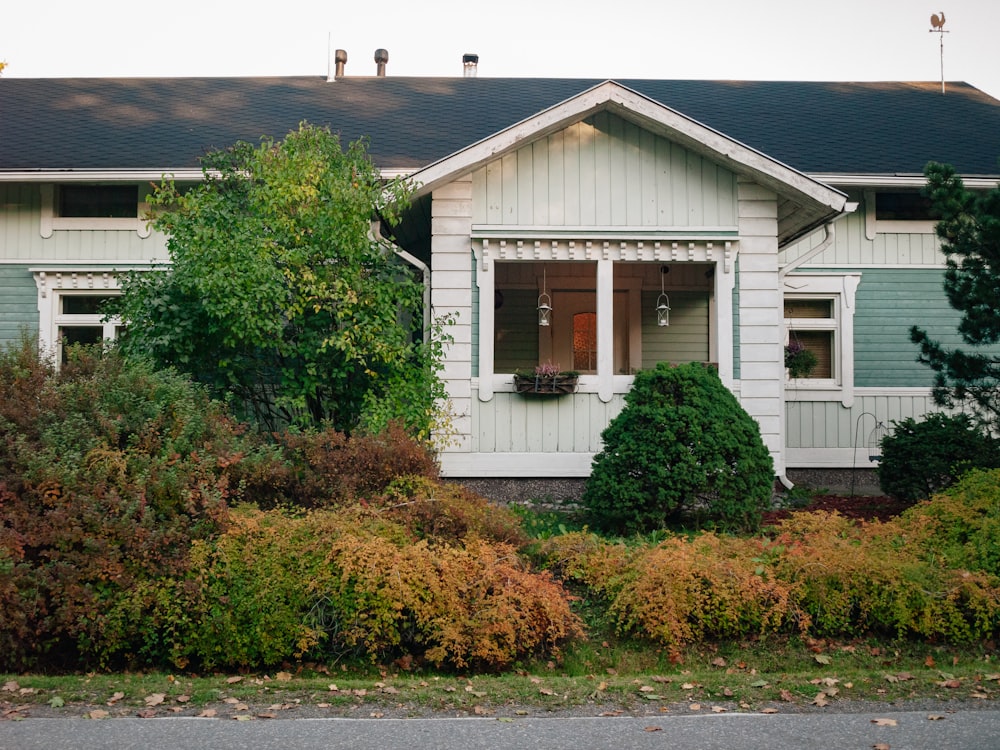 a white house with a black roof and windows