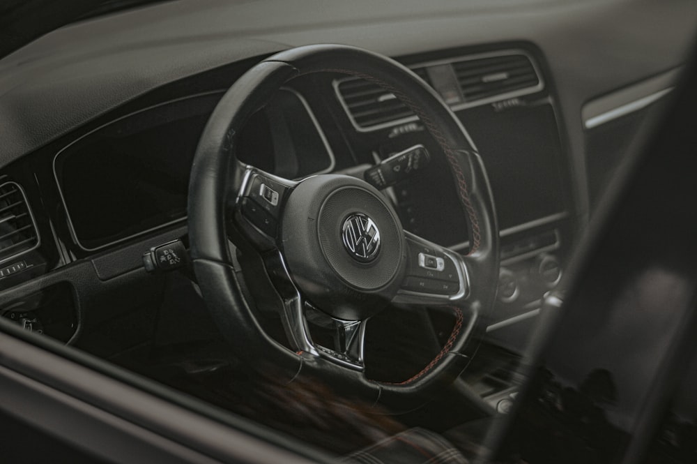 the interior of a car with a steering wheel and dashboard