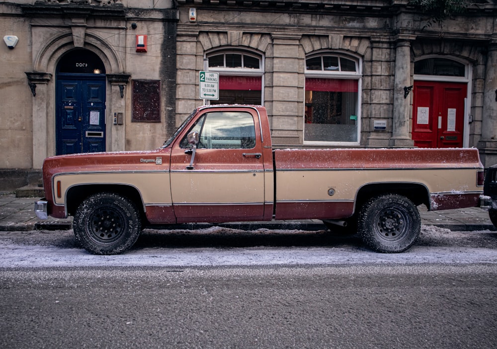 a brown and tan truck parked in front of a building