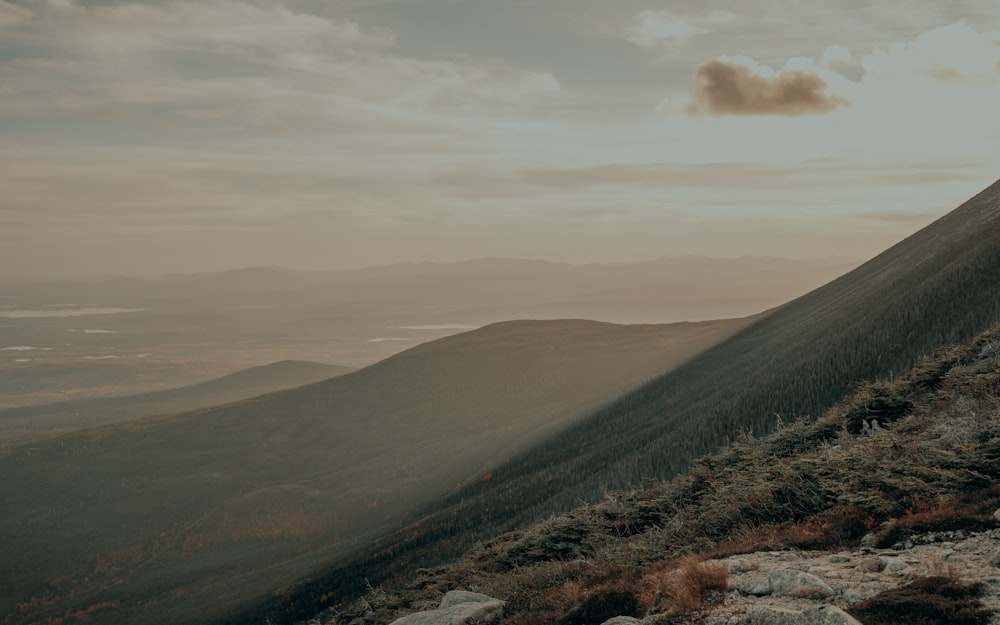 a person walking up a hill on a cloudy day