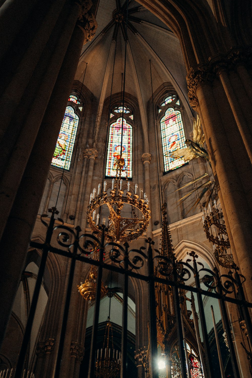 a cathedral with a chandelier and stained glass windows