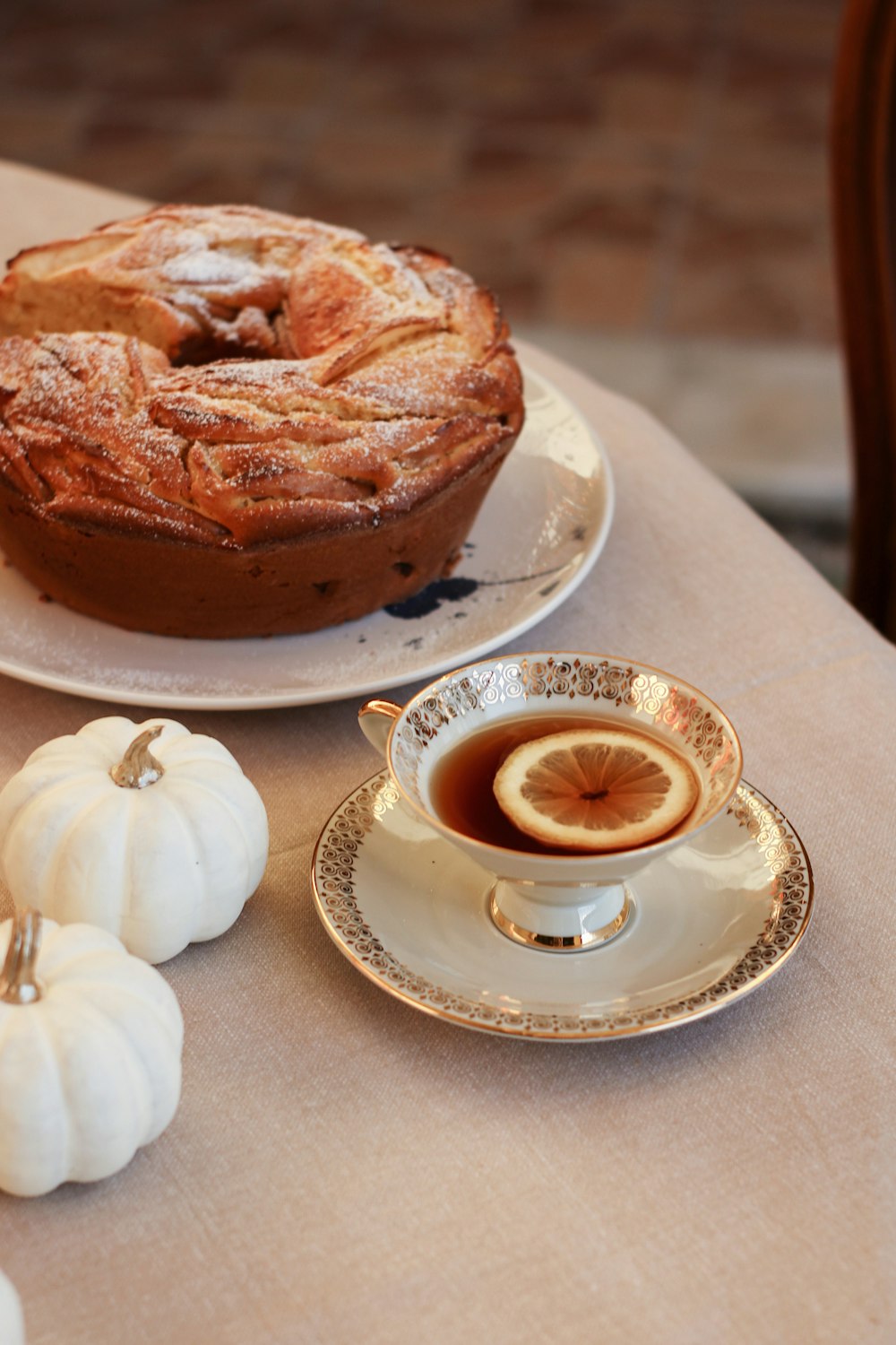 a table topped with a pie and a cup of coffee