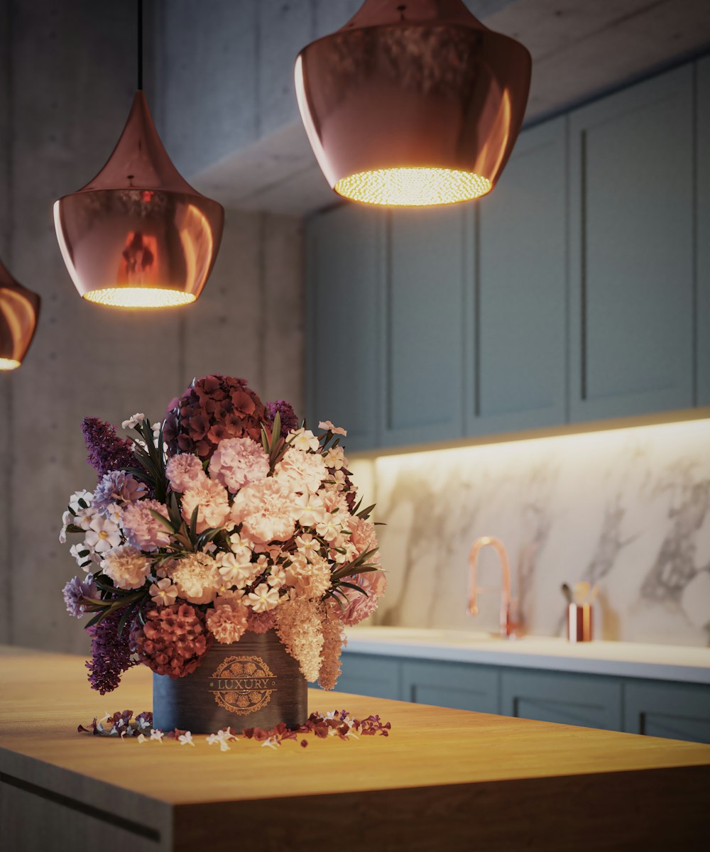 a vase of flowers sitting on a kitchen counter