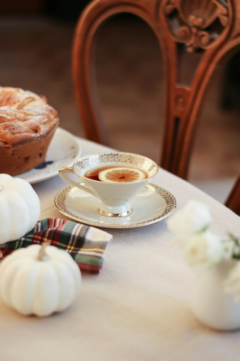 a table topped with a pie and a cup of coffee