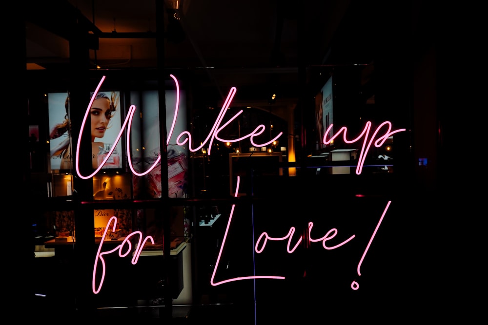 a neon sign that says wake up for love