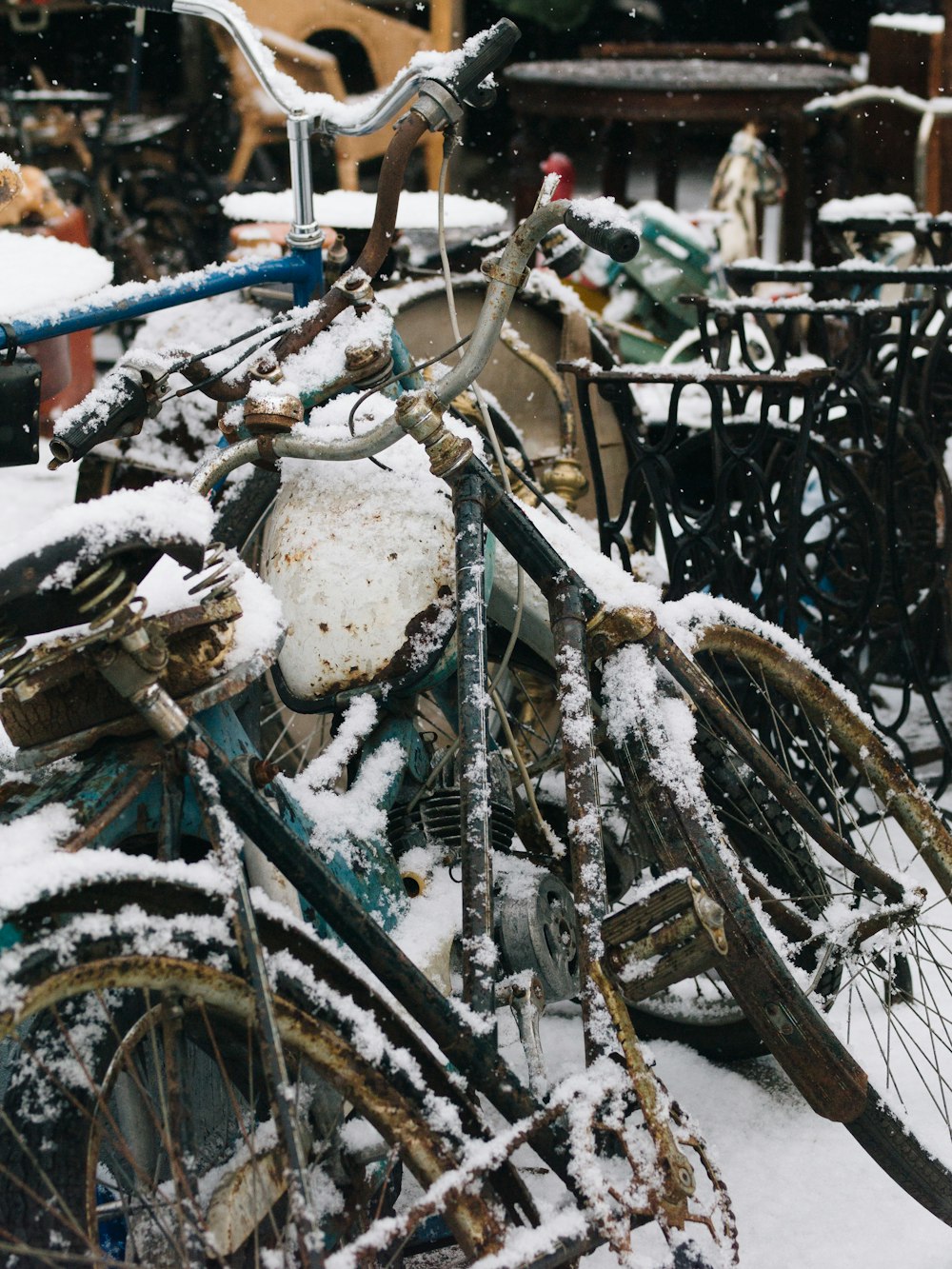 a bicycle covered in snow next to a building