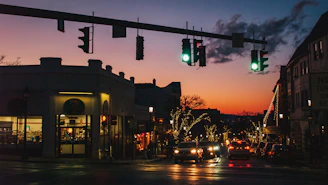 A bustling East Orange street lined with diverse restaurants and colorful signage at sunset.