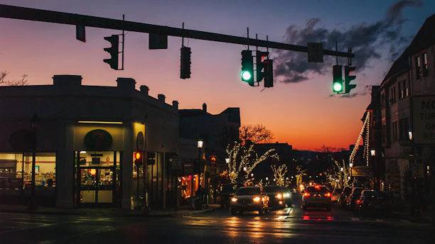 A bustling East Orange street lined with diverse restaurants and colorful signage at sunset.