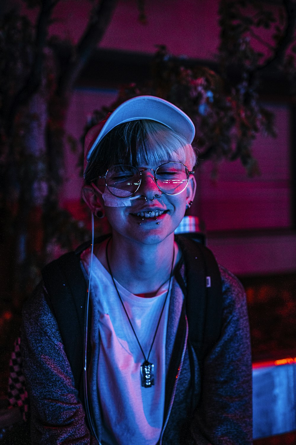 a young man wearing glasses and a hat