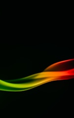A smooth, abstract wave of colors flows against a dark background, transitioning from vibrant red to orange, yellow, and finally green. The colors blend seamlessly, creating a dynamic and fluid motion effect.