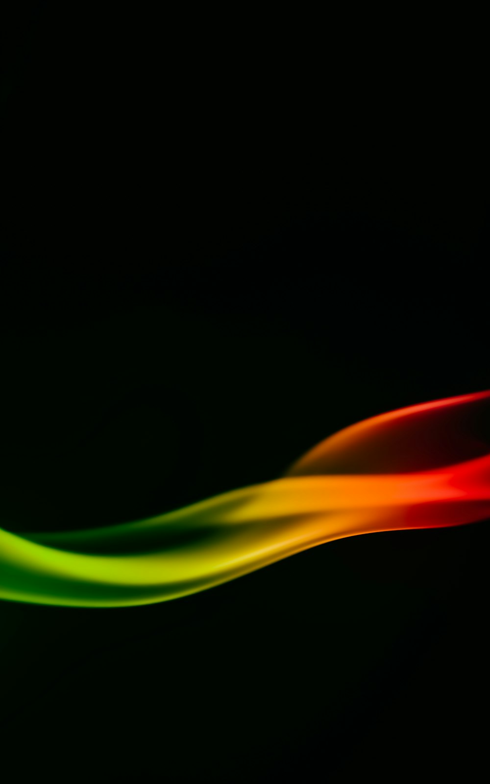 a red, yellow, and green wave on a black background