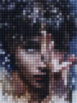 A pixelated image composed of small circles varying in color and shade, forming a mosaic-like abstract representation. The pattern suggests a distorted and artistic rendition of a human face using a grid of circular pixels.