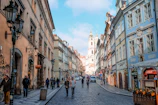 Historic cobblestone streets of Prague with people strolling and chatting.